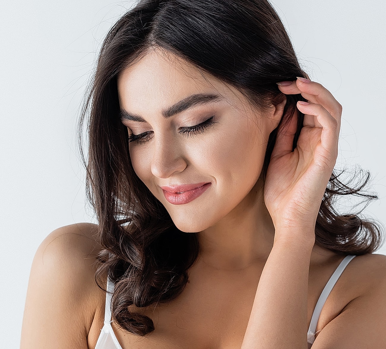 Smiling woman with long dark hair, soft expression.